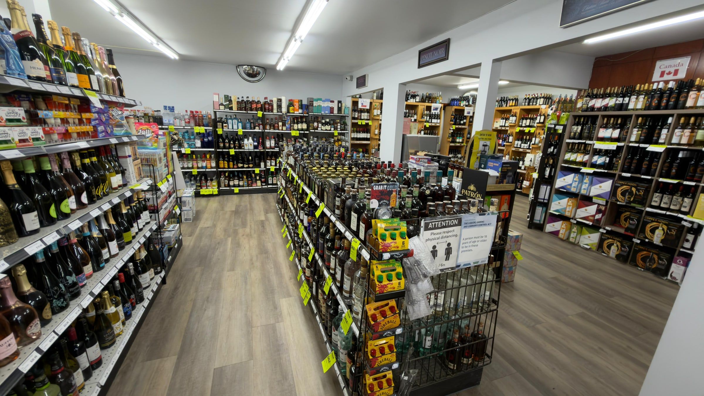The spirits aisle, shelved floor to ceiling with wine racks beyond