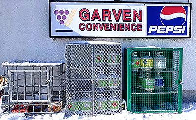 Propane exchange cages outside the store, beneath the Garven Convenience sign