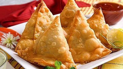 Golden fried samosas filled with peas, onion and potato