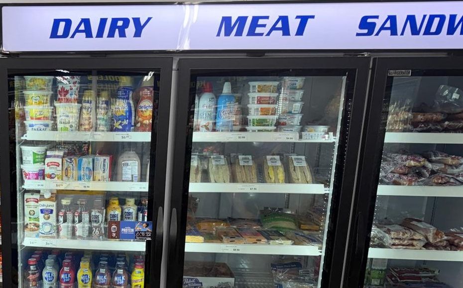 The dairy, meat and sandwich cooler, with packaged sandwiches on the middle shelf